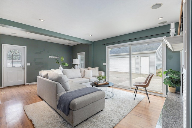 living room with light wood-style floors, recessed lighting, and baseboards