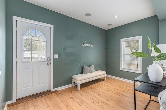 interior space with baseboards, a wealth of natural light, and light wood-type flooring