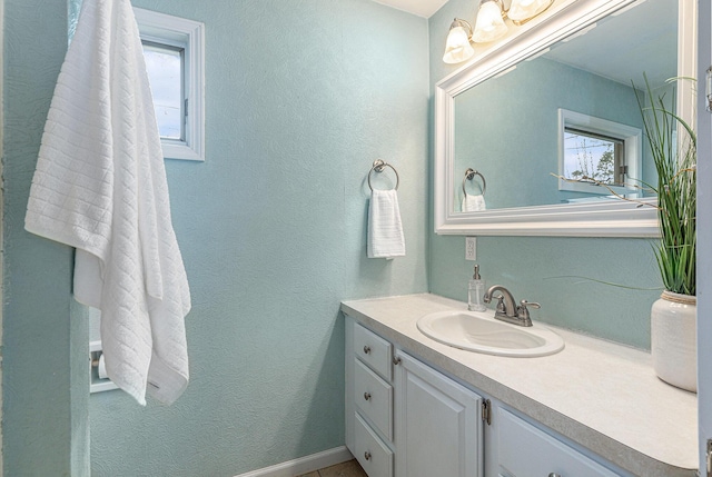 bathroom featuring vanity and a textured wall