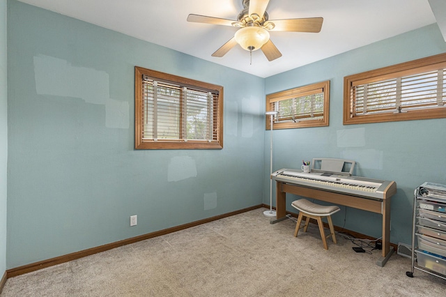 home office with baseboards, light carpet, and ceiling fan