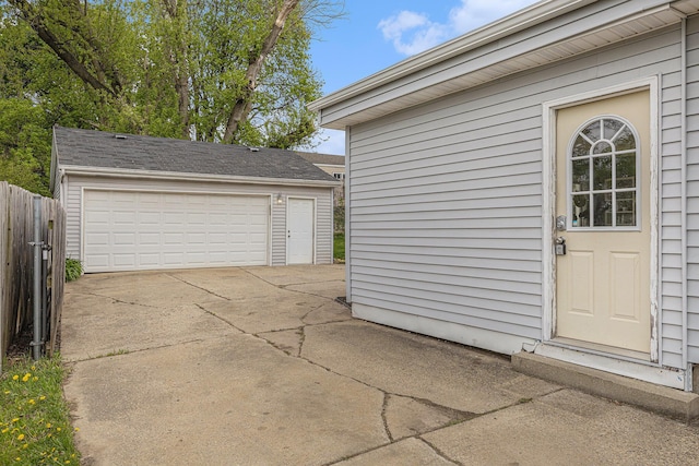 detached garage featuring fence