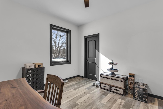 home office with baseboards, ceiling fan, and wood finished floors