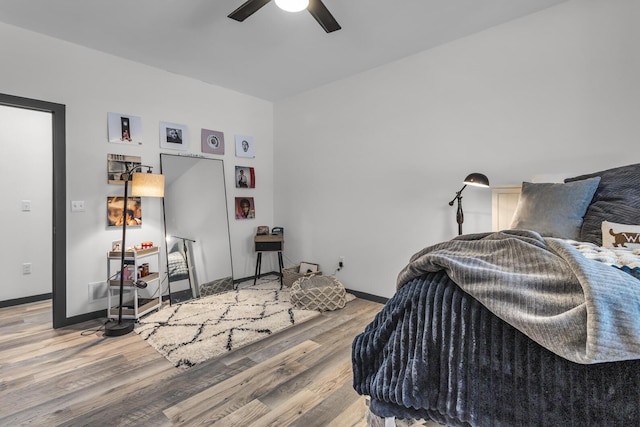 bedroom with baseboards, ceiling fan, and wood finished floors