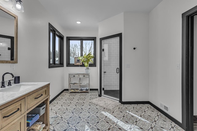 full bathroom with vanity, visible vents, baseboards, recessed lighting, and a shower stall