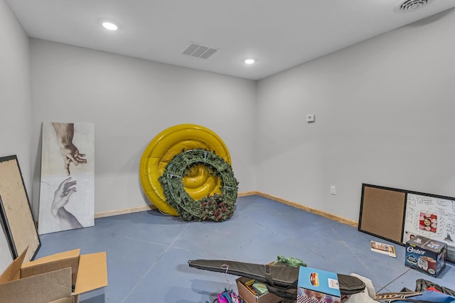 interior space with visible vents, baseboards, and concrete floors