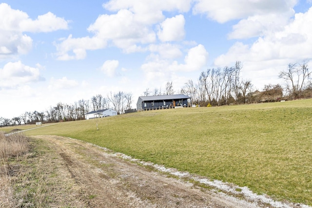 view of yard featuring a rural view and driveway