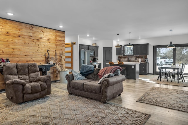 living area with recessed lighting and light wood-type flooring