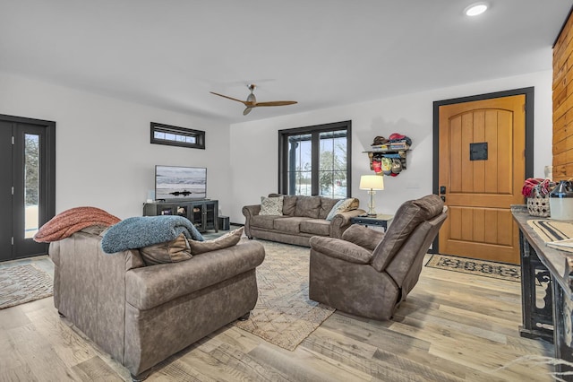 living area with recessed lighting, ceiling fan, and light wood finished floors
