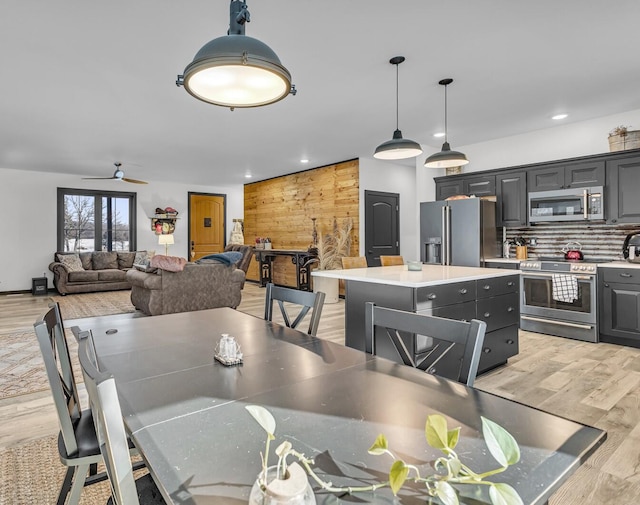 dining area with a ceiling fan, recessed lighting, and light wood-style floors