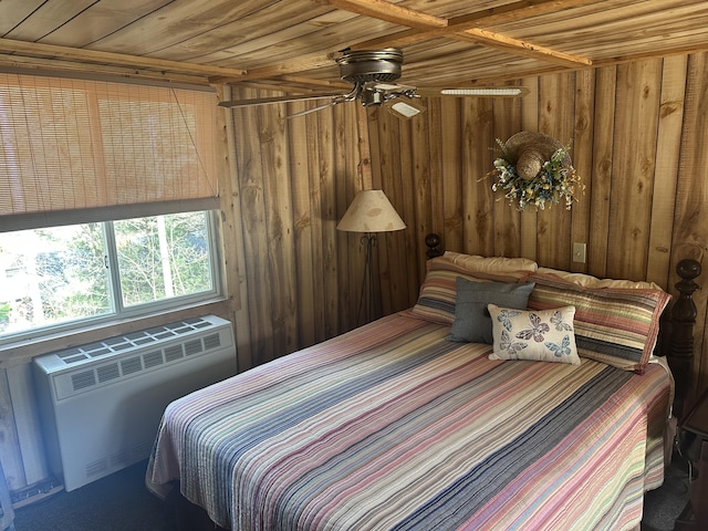 bedroom featuring radiator heating unit, wooden ceiling, and wood walls