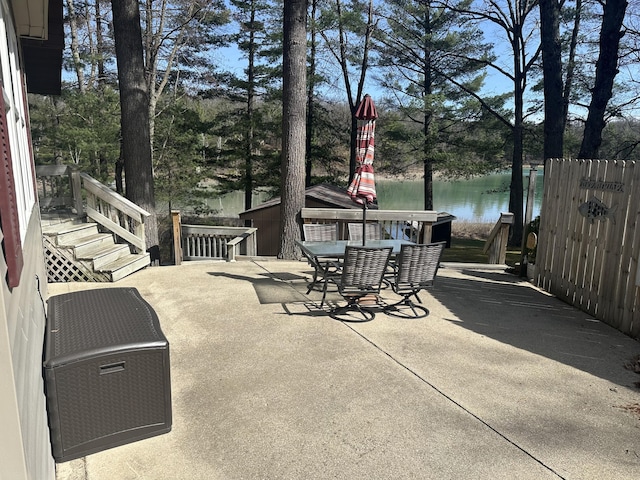 view of patio / terrace with outdoor dining area and a water view