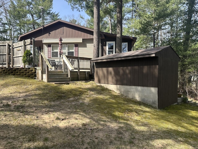 back of property featuring an outdoor structure