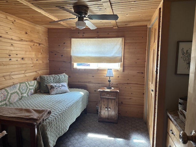 bedroom with wooden walls, ceiling fan, and wood ceiling
