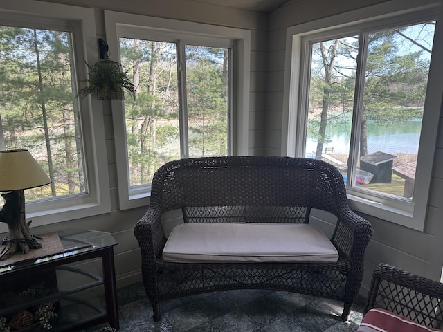 sunroom with a water view and a wealth of natural light