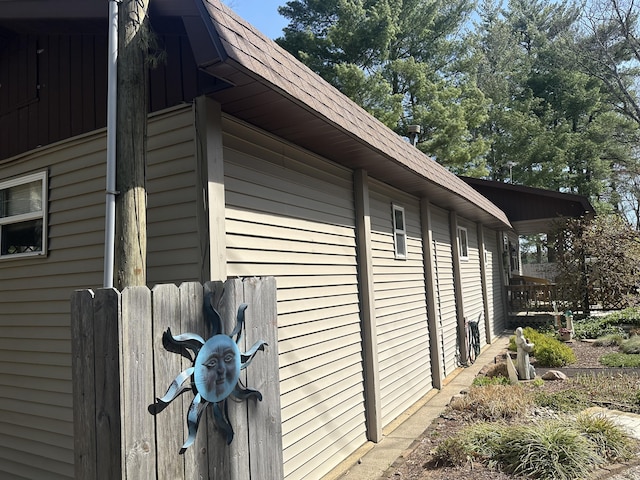 view of side of home featuring roof with shingles