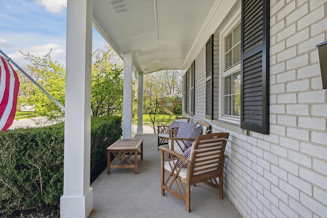 view of patio featuring visible vents and covered porch