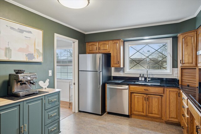 kitchen with a sink, appliances with stainless steel finishes, brown cabinetry, and backsplash