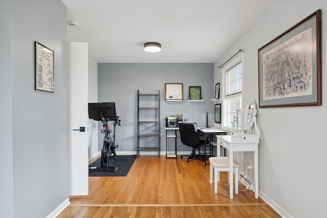 office area featuring light wood-type flooring and baseboards