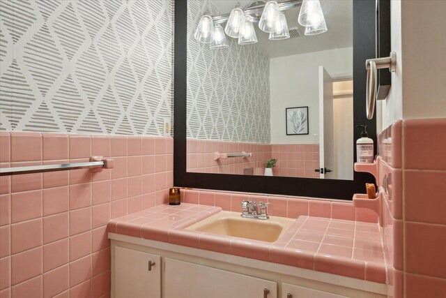 bathroom with tile walls and vanity