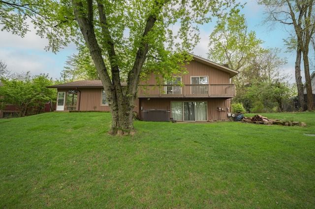 back of house featuring a yard and a deck