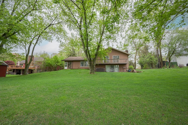view of green lawn featuring a deck