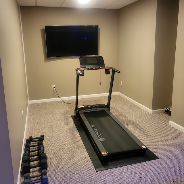 workout area featuring carpet flooring and baseboards