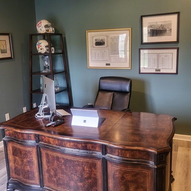 office space with baseboards and wood finished floors