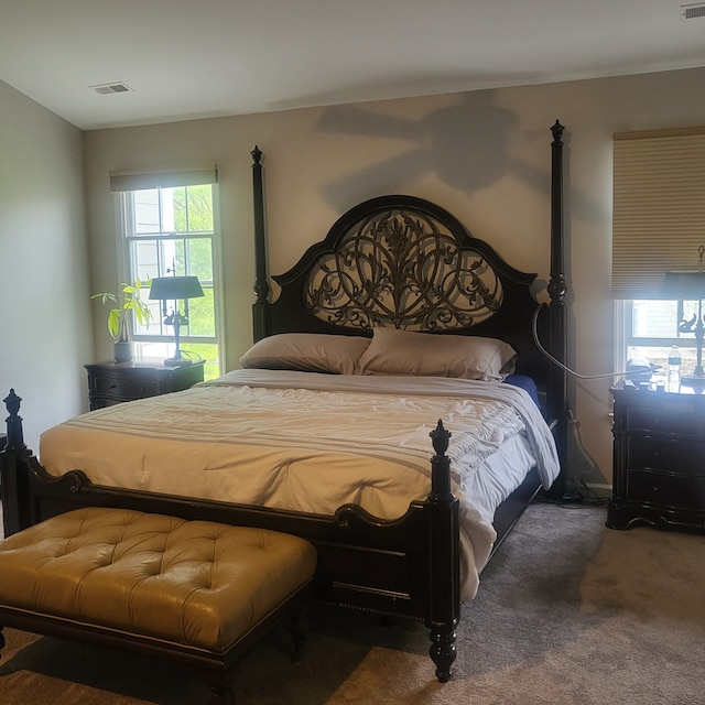 bedroom with visible vents and carpet floors