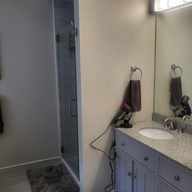 full bathroom featuring a stall shower and vanity