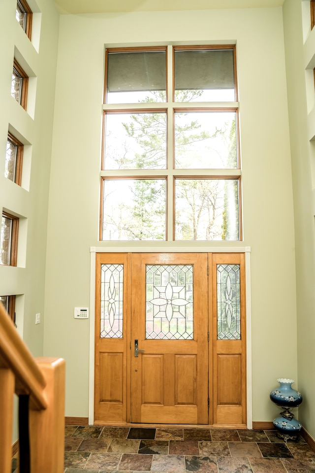 1151 Abseguami Trl, Lake Orion, MI 48362 - foyer featuring stone tile floors, baseboards, and a towering ceiling