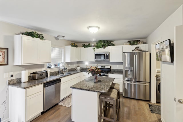13943 Breakfast Dr, Redford, MI 48239 - kitchen with white cabinetry, stainless steel appliances, a kitchen breakfast bar, and a sink