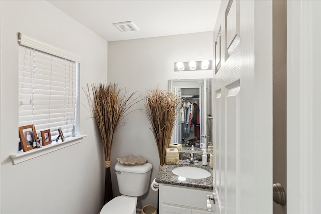 13943 Breakfast Dr, Redford, MI 48239 - bathroom featuring toilet, a spacious closet, vanity, and visible vents