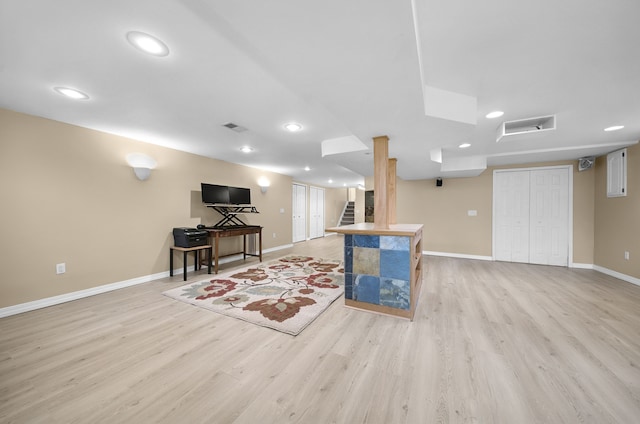 living room featuring recessed lighting, baseboards, and light wood finished floors