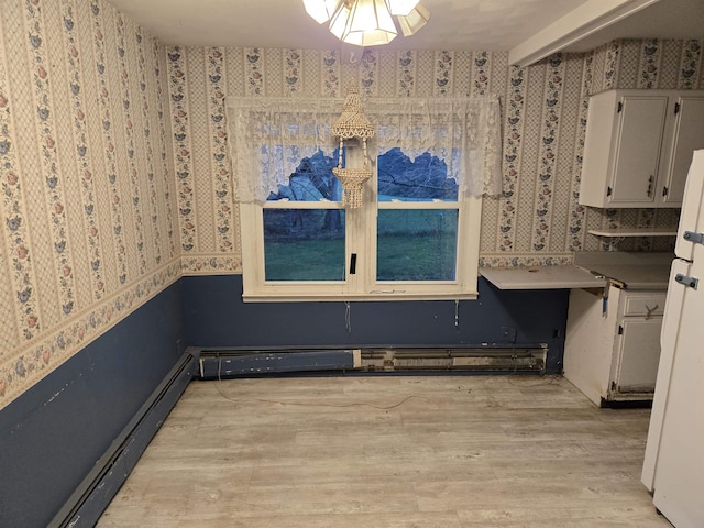 2142 Farnsworth Rd, Lapeer, MI 48446 - unfurnished dining area featuring baseboard heating, light wood-style floors, and wallpapered walls