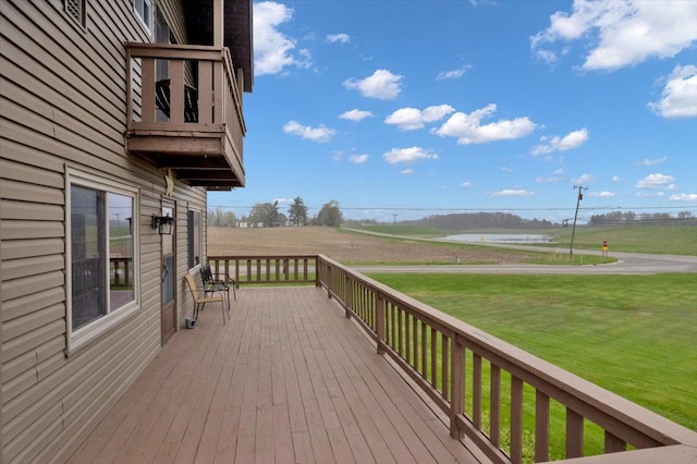 wooden terrace featuring a yard