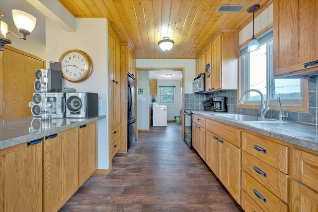 kitchen with wood ceiling, a sink, visible vents, black appliances, and washer / clothes dryer