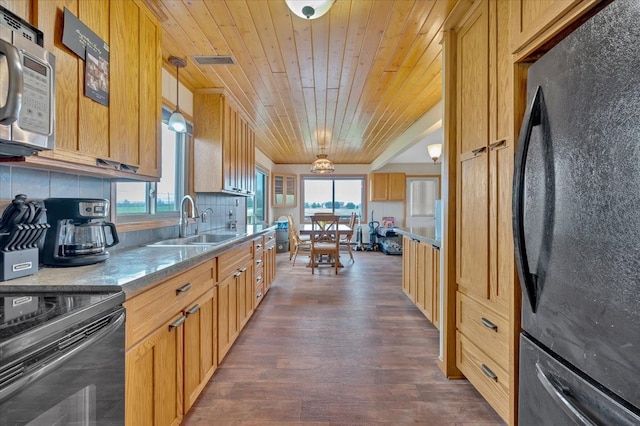 kitchen with a sink, black appliances, dark wood-type flooring, decorative backsplash, and wood ceiling