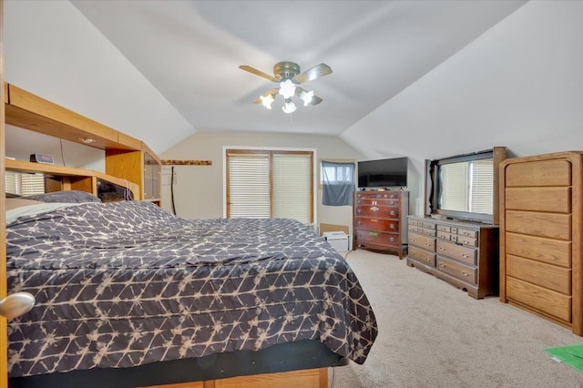 bedroom with vaulted ceiling, ceiling fan, and carpet flooring