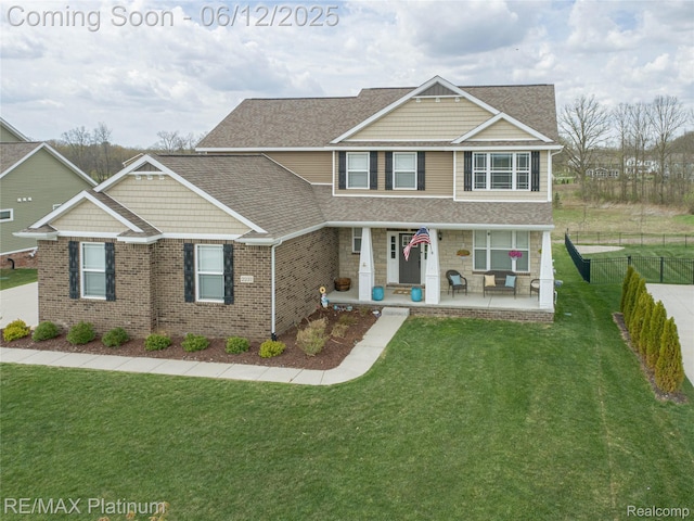 2237 Walnut View Dr, Howell, MI 48855 - craftsman-style home with brick siding, roof with shingles, and a porch