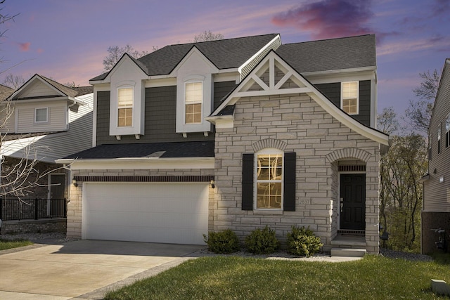 view of front of home with concrete driveway, roof with shingles, an attached garage, and stone siding