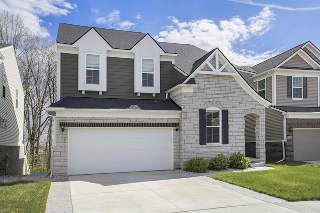 view of front facade with a garage, a shingled roof, driveway, and stone siding
