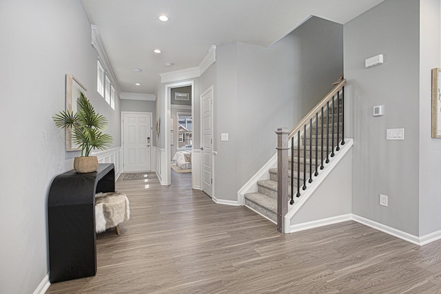entrance foyer featuring baseboards, recessed lighting, wood finished floors, and stairway