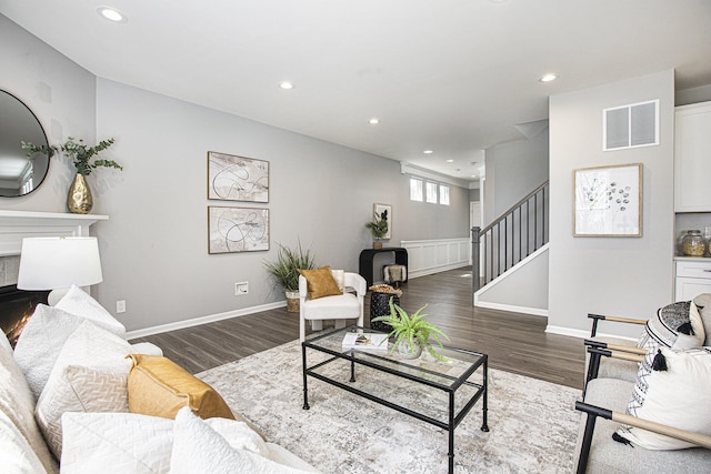 living area featuring visible vents, recessed lighting, stairs, and wood finished floors