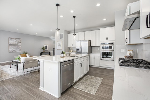 kitchen featuring visible vents, a sink, appliances with stainless steel finishes, and dark wood-style floors