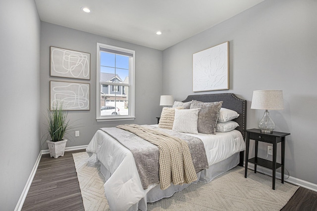 bedroom featuring baseboards, recessed lighting, and wood finished floors