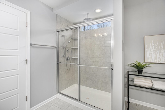 full bathroom featuring recessed lighting, baseboards, tile patterned flooring, and a stall shower
