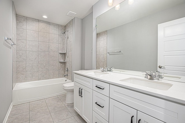 bathroom with shower / bath combination, double vanity, a sink, tile patterned floors, and toilet