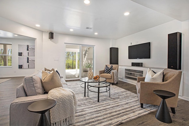 living room featuring baseboards, recessed lighting, wood finished floors, and visible vents