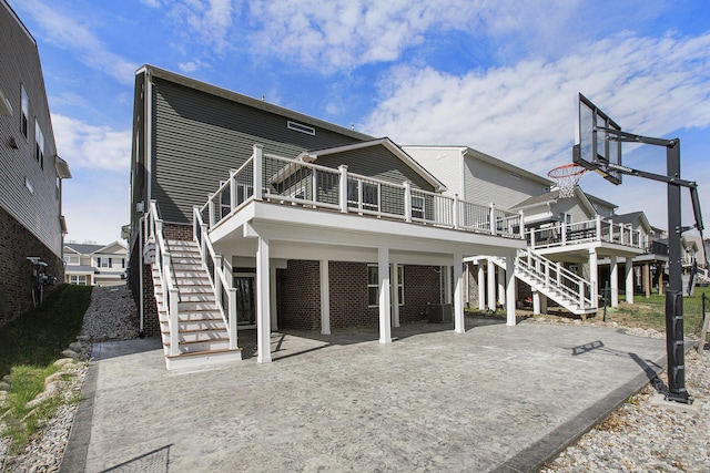 back of house featuring a deck and stairway