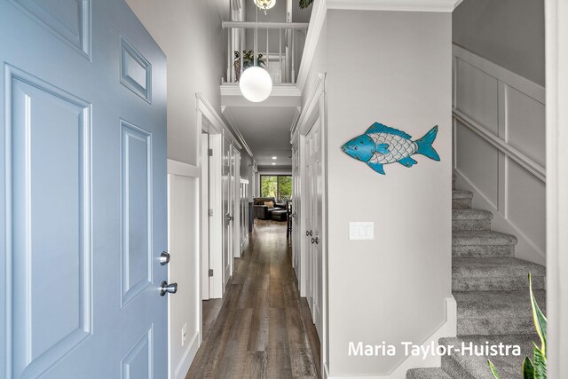 foyer entrance featuring dark wood-style flooring and stairs